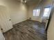 Bedroom featuring gray wood-look floors, a bright window, and a white paneled door at 3681 Melonies Dr # 29, Las Vegas, NV 89103