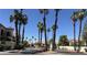 View of the community entrance featuring lush palms, well-maintained landscaping, and secure access at 3681 Melonies Dr # 29, Las Vegas, NV 89103