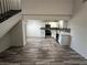 Open concept living area with wood-look flooring leading to the kitchen and staircase at 3681 Melonies Dr # 29, Las Vegas, NV 89103