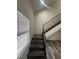 Stairway with gray wood-look flooring and a metal railing near a bright window at 3681 Melonies Dr # 29, Las Vegas, NV 89103