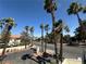 Street view framed by palm trees offers a glimpse of the neighborhood and city skyline at 3681 Melonies Dr # 29, Las Vegas, NV 89103