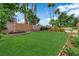 Spacious backyard lawn featuring mature trees, lush greenery, and a private walled perimeter at 3753 Meadowcrest Dr, Las Vegas, NV 89121