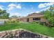 Spacious, well-manicured backyard with green lawn, lush landscaping, and charming home exterior at 3753 Meadowcrest Dr, Las Vegas, NV 89121