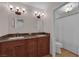 Double vanity bathroom featuring decorative mirrors and light fixtures at 3753 Meadowcrest Dr, Las Vegas, NV 89121