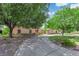 Beautiful home with a circular driveway, mature shade trees, and lush landscaped yard at 3753 Meadowcrest Dr, Las Vegas, NV 89121