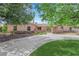 Inviting single-story home with mature trees, a circular driveway, and manicured landscaping at 3753 Meadowcrest Dr, Las Vegas, NV 89121