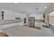 Well-lit kitchen with granite countertops, stainless steel appliances, and open shelving at 3753 Meadowcrest Dr, Las Vegas, NV 89121