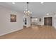 Spacious living room with hardwood floors and a chandelier, creating an inviting atmosphere at 3753 Meadowcrest Dr, Las Vegas, NV 89121