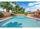 An inviting backyard pool surrounded by lush landscaping, tall palms, and a serene outdoor space at 3753 Meadowcrest Dr, Las Vegas, NV 89121