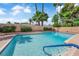 Inviting backyard pool with a blue-tiled edge, set amongst lush greenery and tall palms at 3753 Meadowcrest Dr, Las Vegas, NV 89121