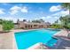 Backyard swimming pool and patio area surrounded by lush landscaping and privacy walls at 3753 Meadowcrest Dr, Las Vegas, NV 89121