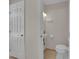 Compact powder room featuring a pedestal sink and toilet, maximizing space efficiency at 3753 Meadowcrest Dr, Las Vegas, NV 89121