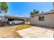 Gravel backyard featuring covered parking, adjacent to a cozy home, offering a practical and low-maintenance outdoor space at 4168 Wendy Ln, Las Vegas, NV 89115