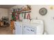 Functional laundry area with washer, dryer, and shelving at 4168 Wendy Ln, Las Vegas, NV 89115