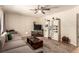 Comfortable living room with sectional sofa, neutral rug, and a ceiling fan at 4168 Wendy Ln, Las Vegas, NV 89115