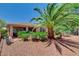 Backyard showcasing a house, desert landscaping, a mature palm tree, and a seating area at 4174 Cascada Piazza Ln, Las Vegas, NV 89135