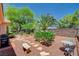 Well-maintained backyard with stone pathways, mature trees, and a cozy seating area at 4174 Cascada Piazza Ln, Las Vegas, NV 89135