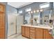 Bright bathroom with a glass-enclosed shower, large vanity, and ample storage at 4174 Cascada Piazza Ln, Las Vegas, NV 89135