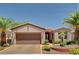 Charming single-story home with a well-manicured front yard, desert landscaping, and an attached two-car garage at 4174 Cascada Piazza Ln, Las Vegas, NV 89135