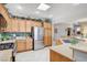 Kitchen with stainless steel appliances, granite counters, and wooden cabinetry at 4174 Cascada Piazza Ln, Las Vegas, NV 89135
