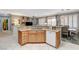 Well-equipped kitchen with counter seating and a view of the dining and living areas at 4174 Cascada Piazza Ln, Las Vegas, NV 89135