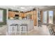 Bright kitchen featuring wooden cabinets, a breakfast bar, and open access to other living areas at 4174 Cascada Piazza Ln, Las Vegas, NV 89135