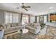 Open concept living room with neutral walls, tile floors, and shutters at 4174 Cascada Piazza Ln, Las Vegas, NV 89135