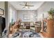 Comfortable living room with contemporary decor, plush seating, and natural light from the windows at 4174 Cascada Piazza Ln, Las Vegas, NV 89135
