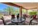 Inviting covered patio with comfortable seating and lush landscaping, perfect for outdoor relaxation at 4174 Cascada Piazza Ln, Las Vegas, NV 89135