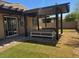 Backyard showcases a cozy outdoor seating area beneath a pergola on a patio at 4337 Stardusk Falls Ave, North Las Vegas, NV 89084