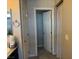 Neutral bathroom featuring a tiled floor and a shower curtain, adjacent to another room at 4337 Stardusk Falls Ave, North Las Vegas, NV 89084
