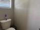 Compact powder room features white toilet and blinds at 4337 Stardusk Falls Ave, North Las Vegas, NV 89084