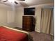 Bedroom features a TV, ceiling fan and bureau offering modern elegance at 4337 Stardusk Falls Ave, North Las Vegas, NV 89084