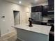 Bright kitchen with a large island, modern appliances, and dark cabinets at 4337 Stardusk Falls Ave, North Las Vegas, NV 89084