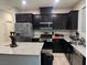 Modern kitchen with dark cabinets, stainless steel appliances, and a large island at 4337 Stardusk Falls Ave, North Las Vegas, NV 89084