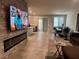 Open concept living area with tile floors, modern fireplace, and dining area with large windows at 4337 Stardusk Falls Ave, North Las Vegas, NV 89084