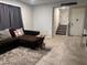 Comfortable living room with a gray patterned rug, sofa, and tile flooring at 4337 Stardusk Falls Ave, North Las Vegas, NV 89084