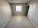This bedroom features neutral walls, tile flooring, and a window with outside views at 435 Mesa Blvd # 202, Mesquite, NV 89027