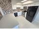 Bright kitchen boasts white cabinetry, quartz countertops, stainless steel appliances, and stylish backsplash at 435 Mesa Blvd # 202, Mesquite, NV 89027