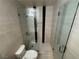 Walk-in shower with sleek glass doors, neutral tile, and convenient shelving at 435 Mesa Blvd # 202, Mesquite, NV 89027