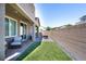 Cozy backyard area features artificial turf and a brick patio area at 4376 Latitude Valley Ct, North Las Vegas, NV 89084