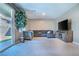 Spacious living room with a comfortable gray sectional couch and sliding door to the backyard at 4376 Latitude Valley Ct, North Las Vegas, NV 89084