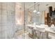 Modern bathroom with a glass-enclosed shower, double sinks, and marble accents at 4381 W Flamingo Rd # 1512, Las Vegas, NV 89103