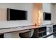Bright desk area with built-in shelves, lighting and dual-mounted flatscreen televisions at 4381 W Flamingo Rd # 1512, Las Vegas, NV 89103