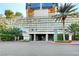 Hotel entrance featuring lush greenery, prominent signage, and architectural details at 4381 W Flamingo Rd # 1512, Las Vegas, NV 89103