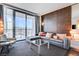 Modern living room featuring a comfortable gray sofa, glass coffee table, and a view of the Palms Casino Resort at 4381 W Flamingo Rd # 1512, Las Vegas, NV 89103