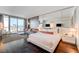 Spacious main bedroom featuring a comfortable king bed, lounge area, and city views from floor-to-ceiling windows at 4381 W Flamingo Rd # 1512, Las Vegas, NV 89103
