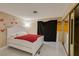 Bright bedroom featuring light tile floors, mirrored closet, and a cozy queen-size bed at 4420 Rich Dr # B, Las Vegas, NV 89102