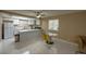 Open concept kitchen with white cabinetry, stainless steel appliances, and breakfast bar seating at 4420 Rich Dr # B, Las Vegas, NV 89102