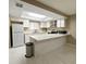 Bright kitchen with white cabinets, updated appliances, and a functional breakfast bar at 4420 Rich Dr # B, Las Vegas, NV 89102